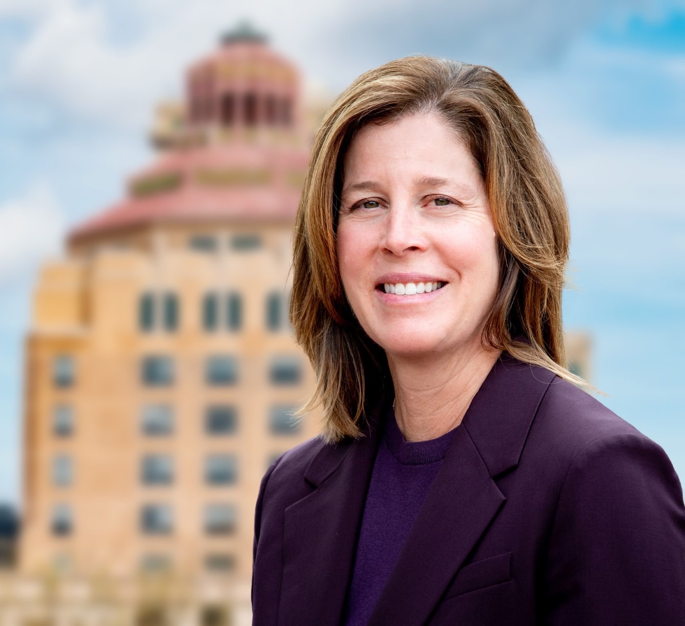 Esther Manheimer smiling in front of Asheville City Hall