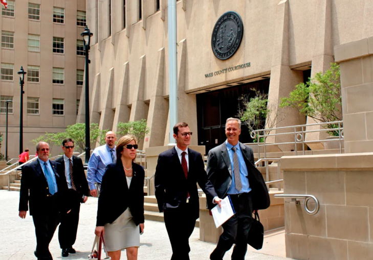 Asheville Mayor Esther Manheimer (front left) and City Councilman Marc Hunt (front right) leave Wake County Superior Court following a 2014 hearing on the future ownership of the city's municipal water system. File photo by Kirk Ross/Carolina Public Press